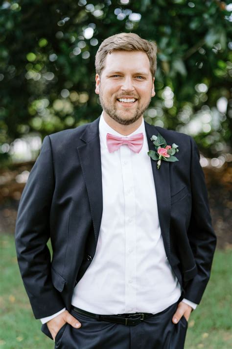 black suit pink bow tie.